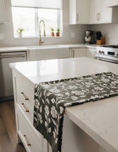 Load image into Gallery viewer, Floral patterned fabric draped over a wooden chair